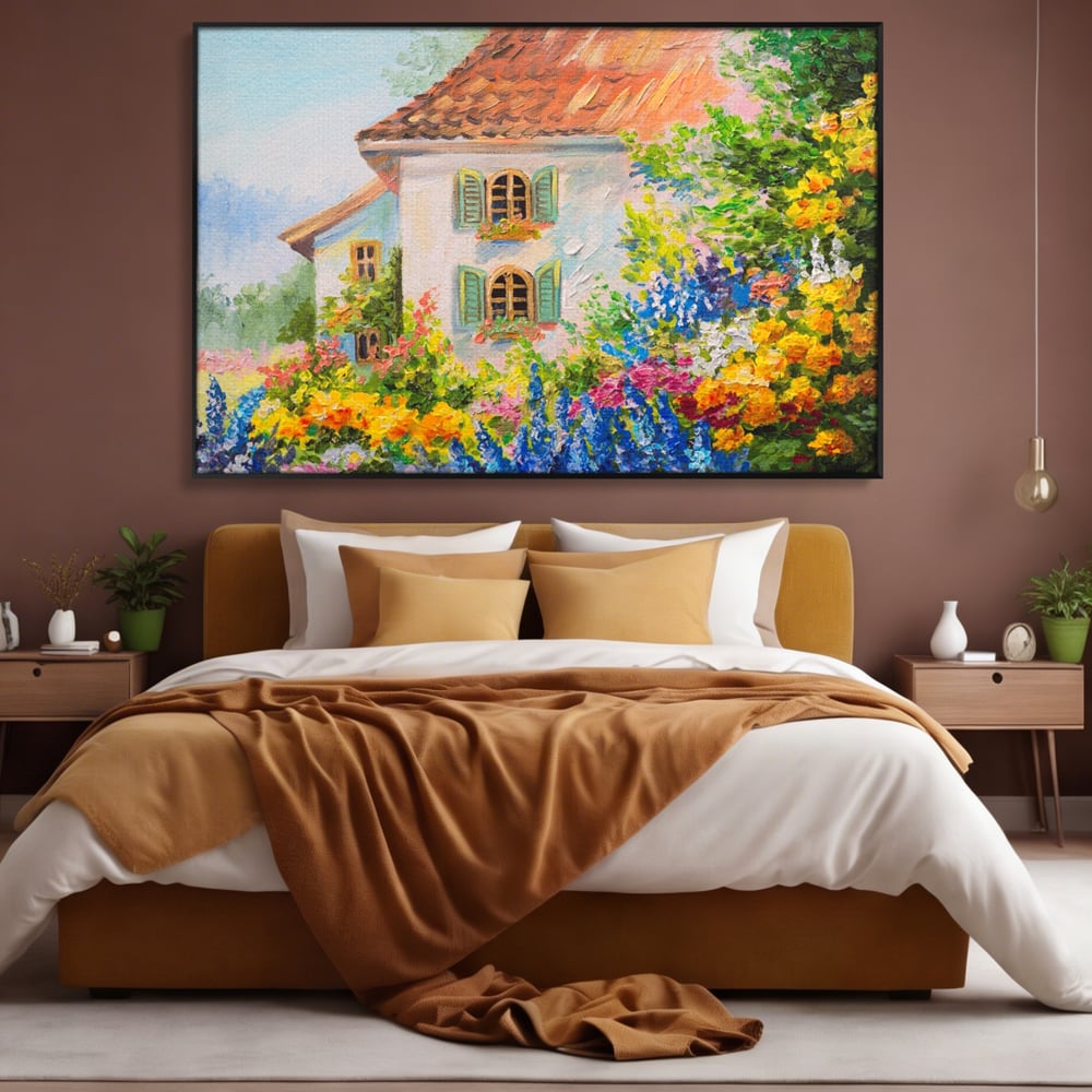 Tablou canvas cu pictura cu casa alba si flori, in rama de aluminiu negru, pe perete intr-un dormitor